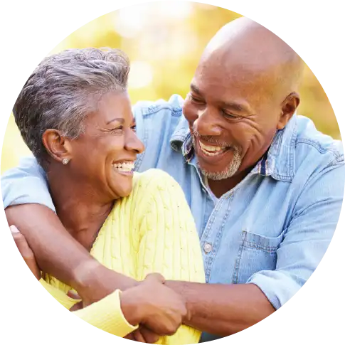 Senior couple smiling and embracing outdoors