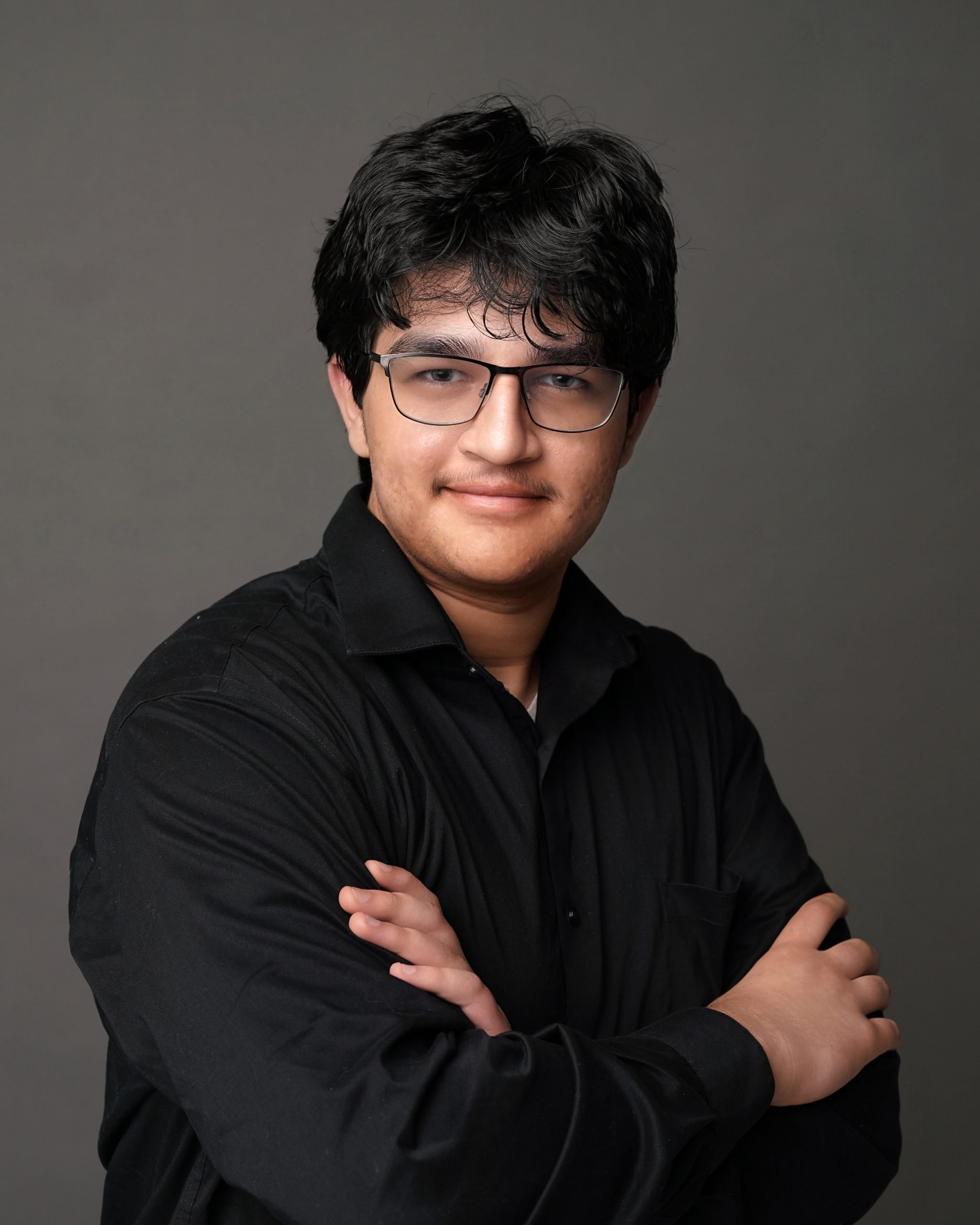 Man wearing glasses with arms crossed portrait