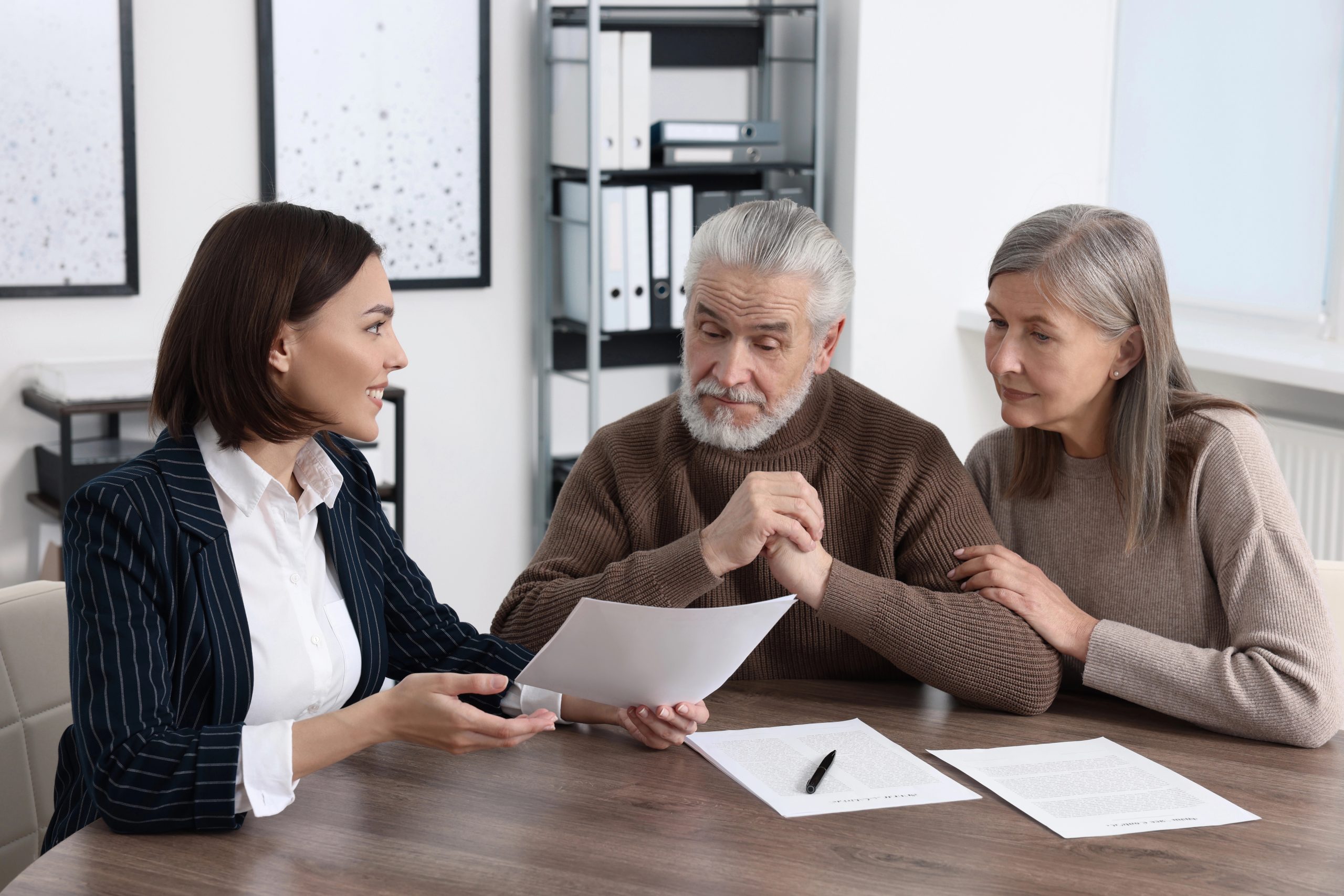 Attorney reviewing documents with a senior couple