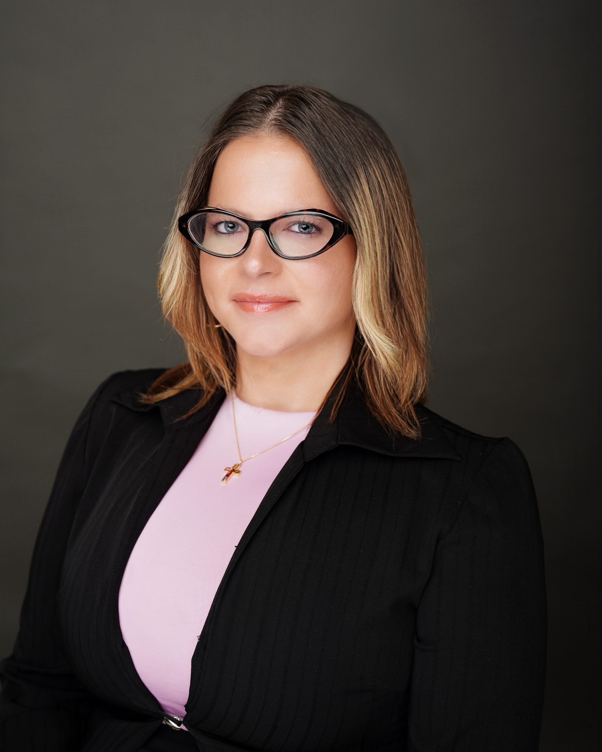 Professional headshot of woman with glasses